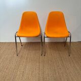 Two orange plastic pollak chairs at Orly airport