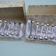 12 bolt-shaped knife rests in their original vintage box