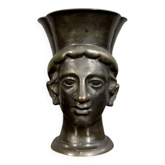Antique bronze vase with a young man's head and medal patina