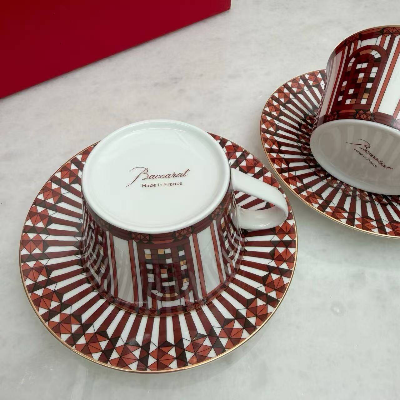 Pair of Baccarat Porcelain Coffee Cups and Saucers, Red Geometric Design