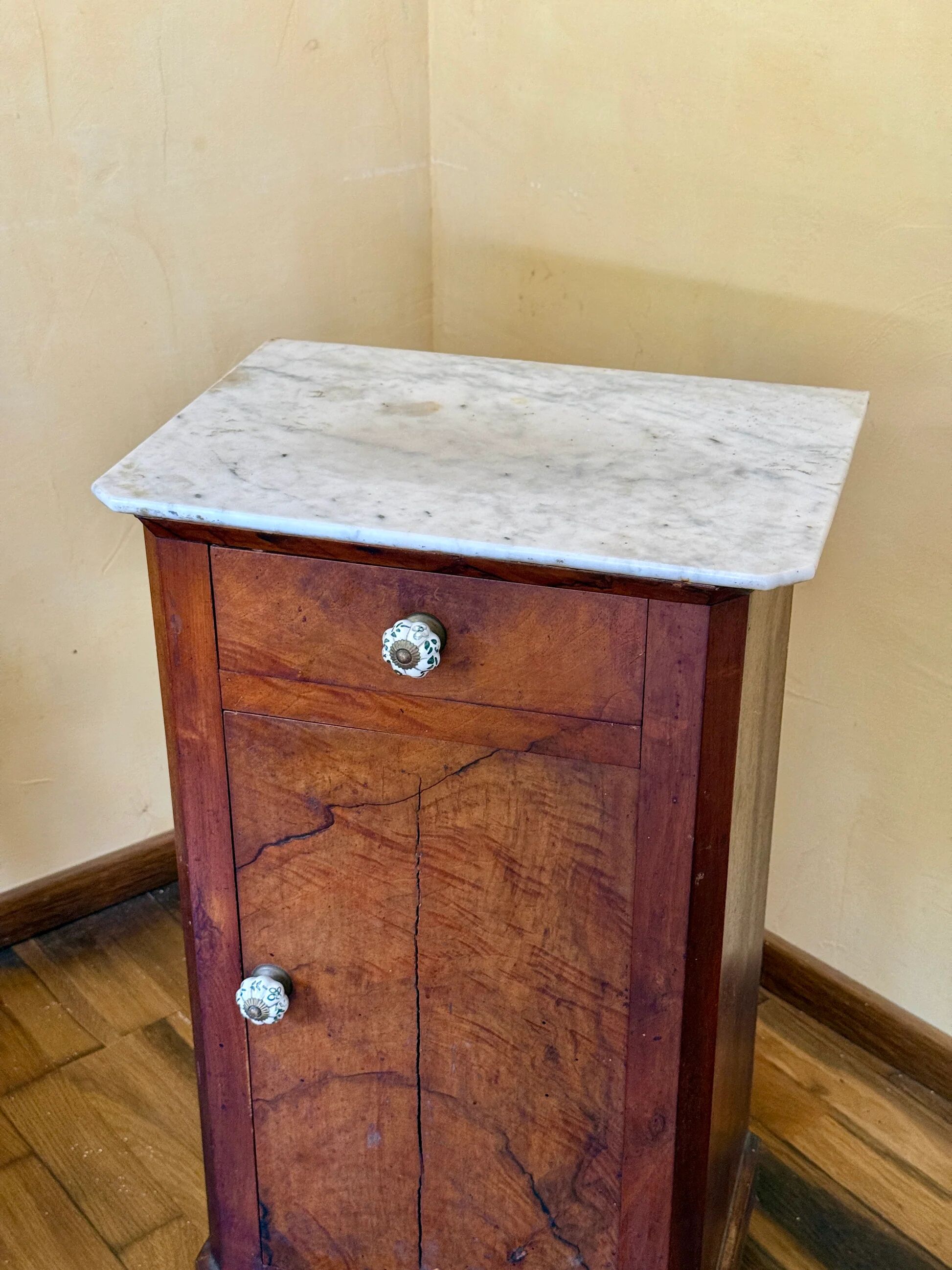 Wood and marble side table with ceramic handles.