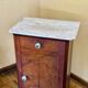 Wood and marble side table with ceramic handles.