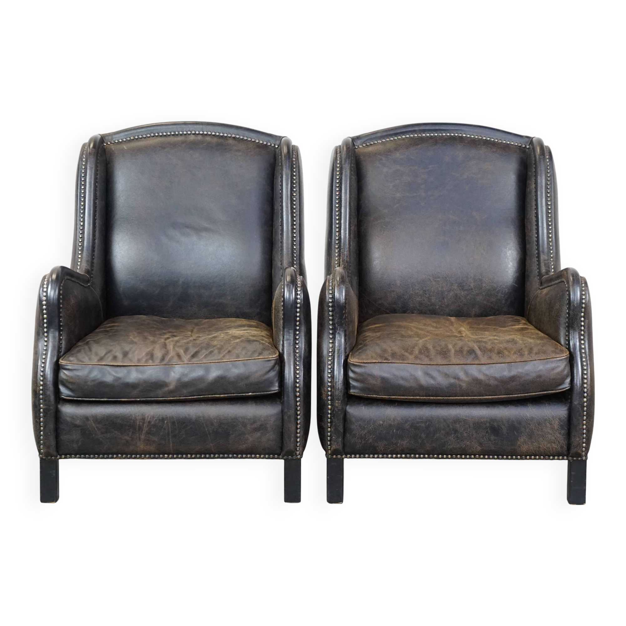 Set of 2 black cow leather armchairs finished with decorative nails, industrial style