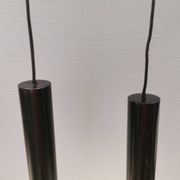 Two cylinder-shaped hanging lamps in black lacquer