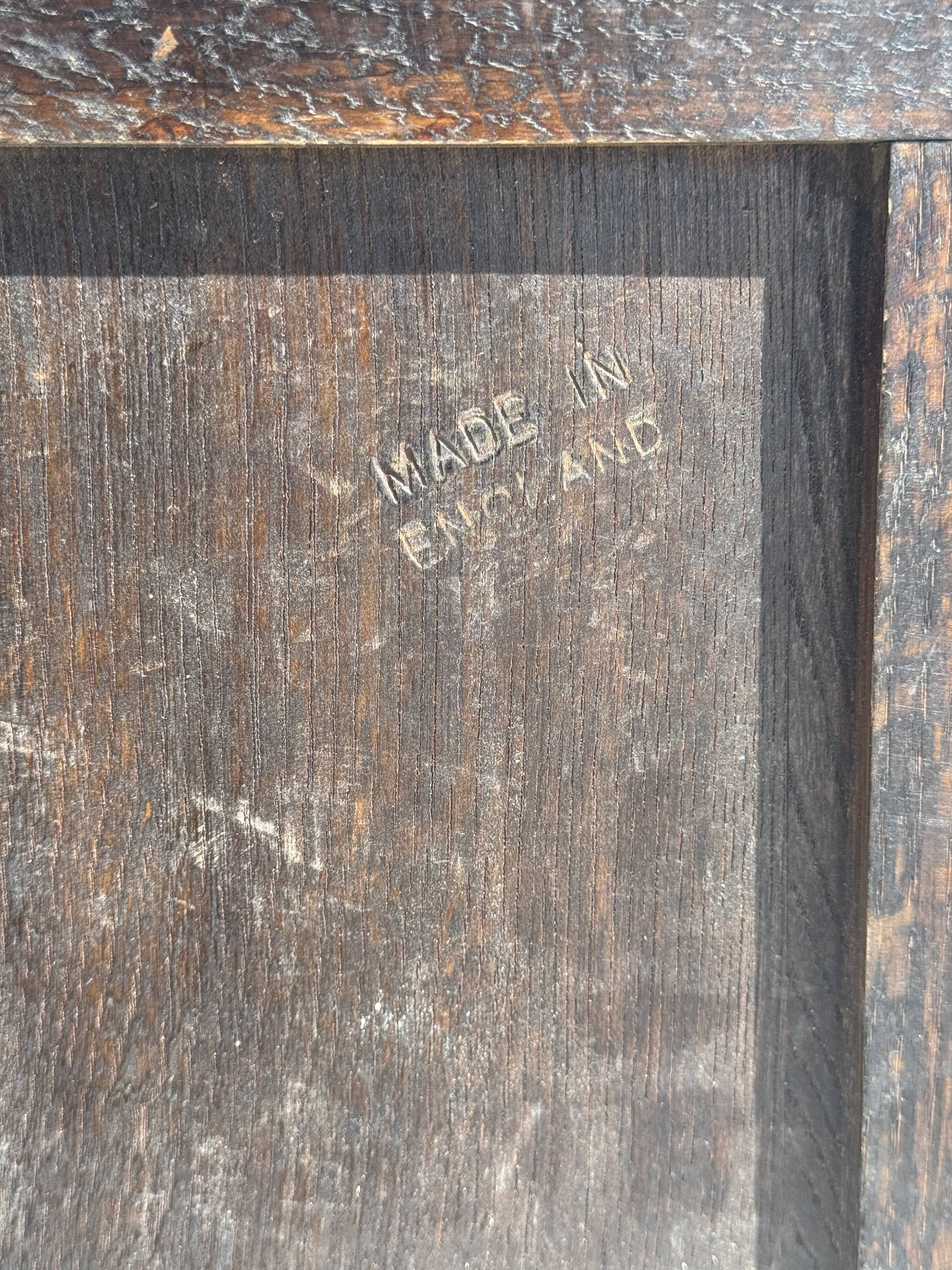 Small antique English rectangular mirror with pediment and oak frame