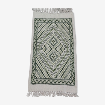 Traditional hand-woven white and green carpet