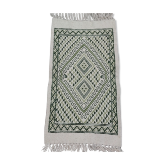 Traditional hand-woven white and green carpet