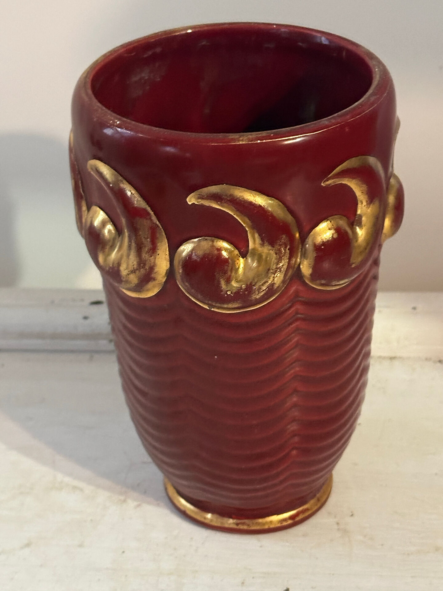 Mid-century relief vase in ruby red enhanced with gilding.
