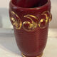 Mid-century relief vase in ruby red enhanced with gilding.
