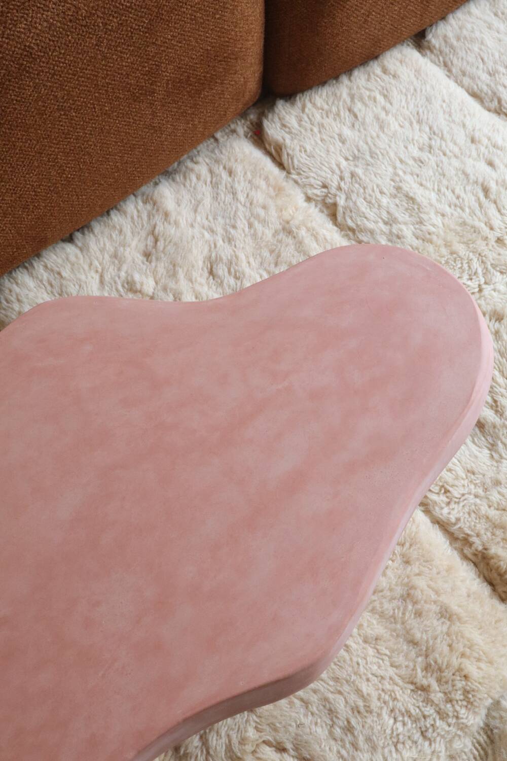 Organic shaped coffee table in pink teracotta tadelakt