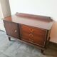 Dark wood sideboard with brass finishes and compass feet