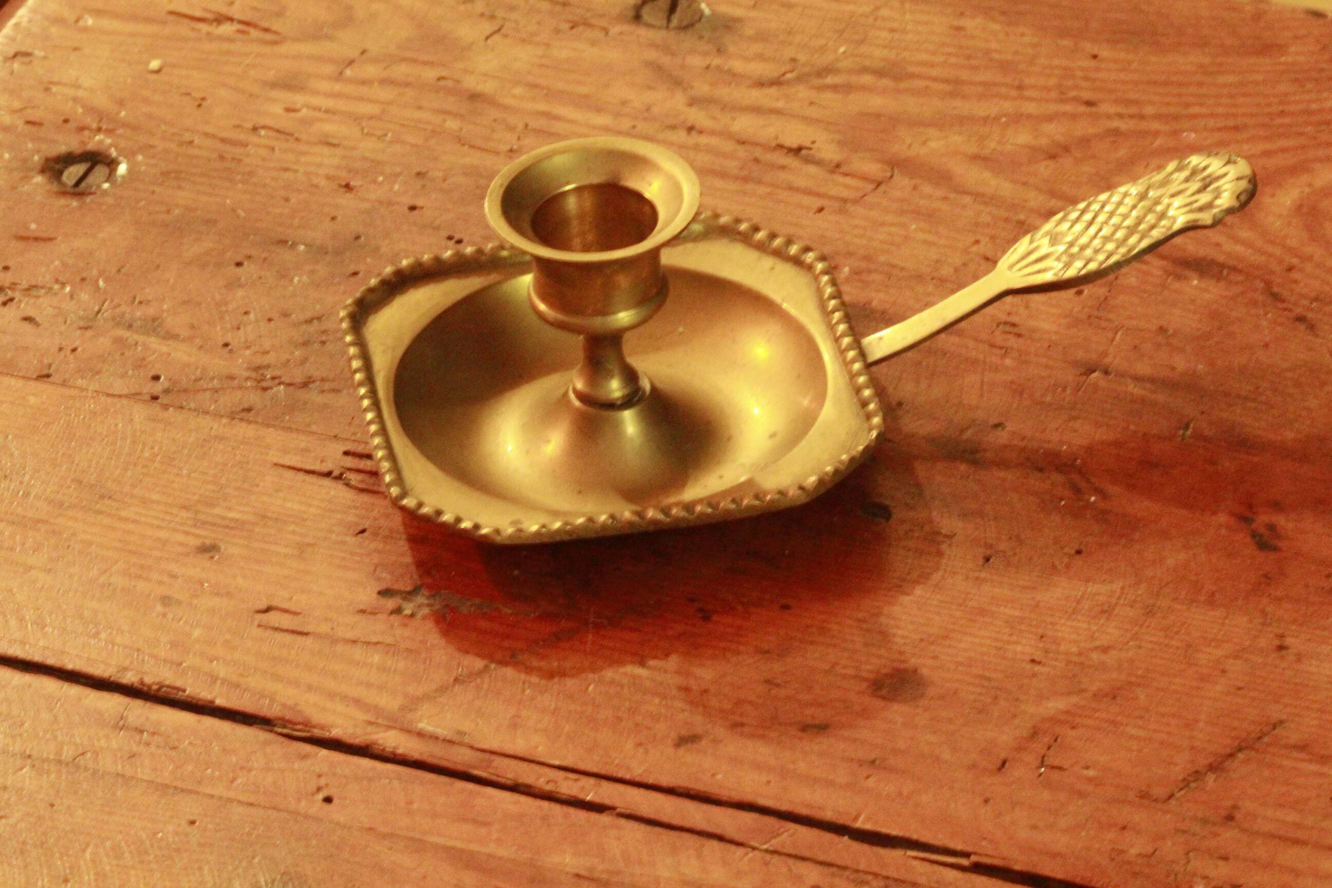 Old brass hand candle holder