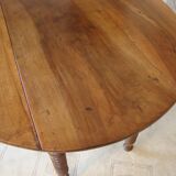 Mid-19th-century walnut round table with shutters, flaps