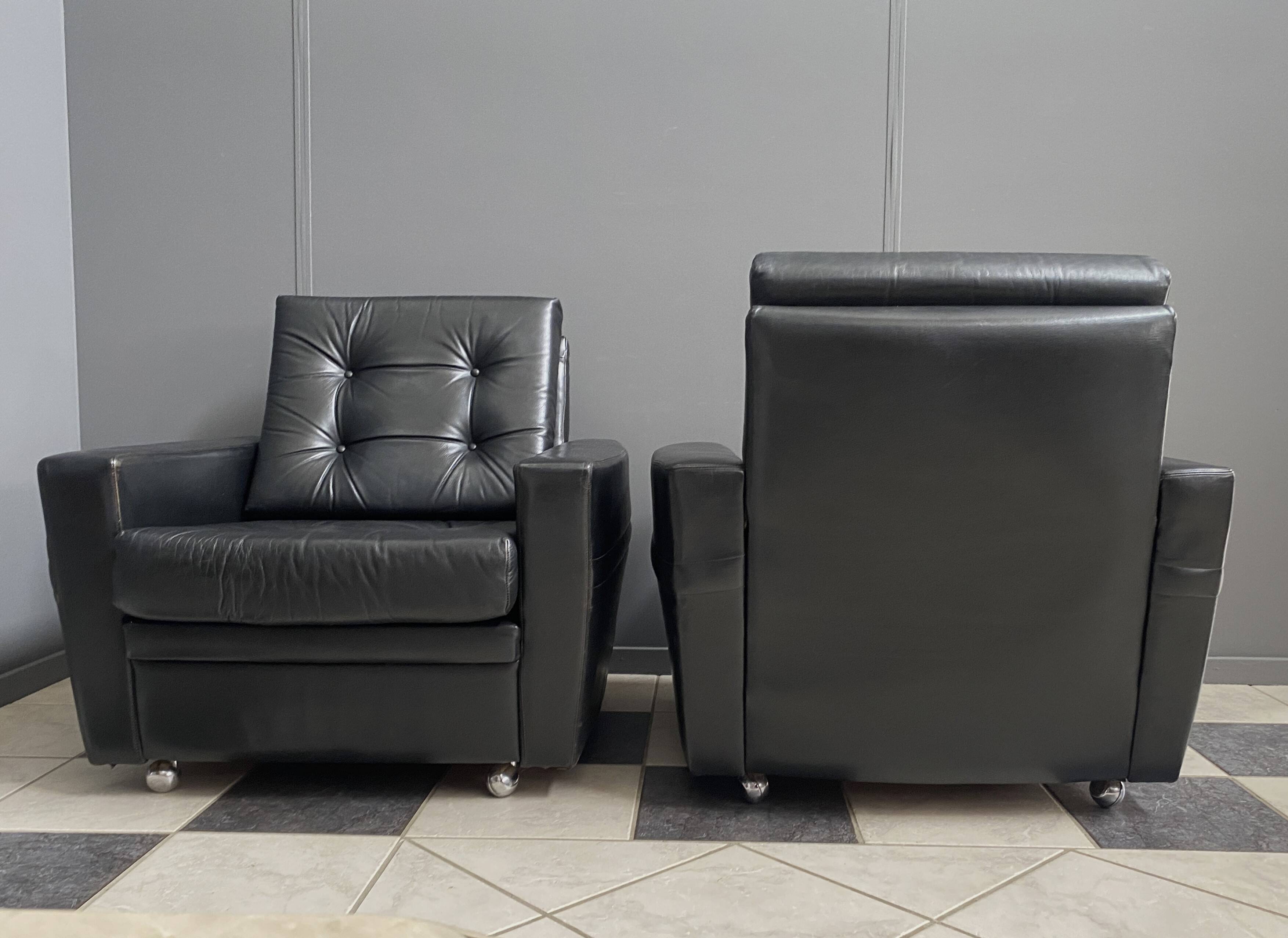 2 Black leather arm chairs 1960s on wheels