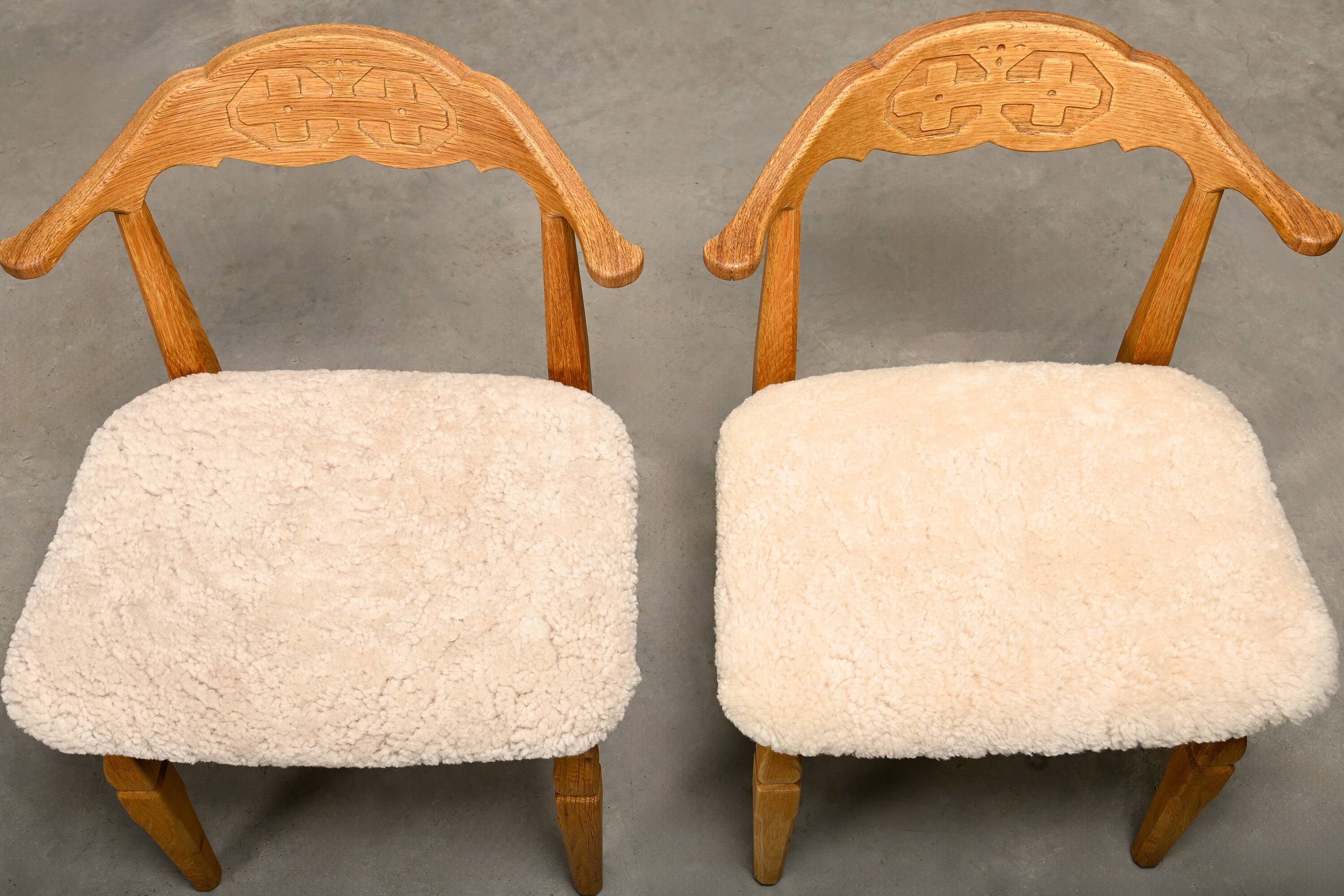 Henning Kjærnulf dining chairs set in Oak and Sheepskin, Denmark, 1960s