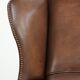 Cowhide wingback armchair in English style finished with decorative nails
