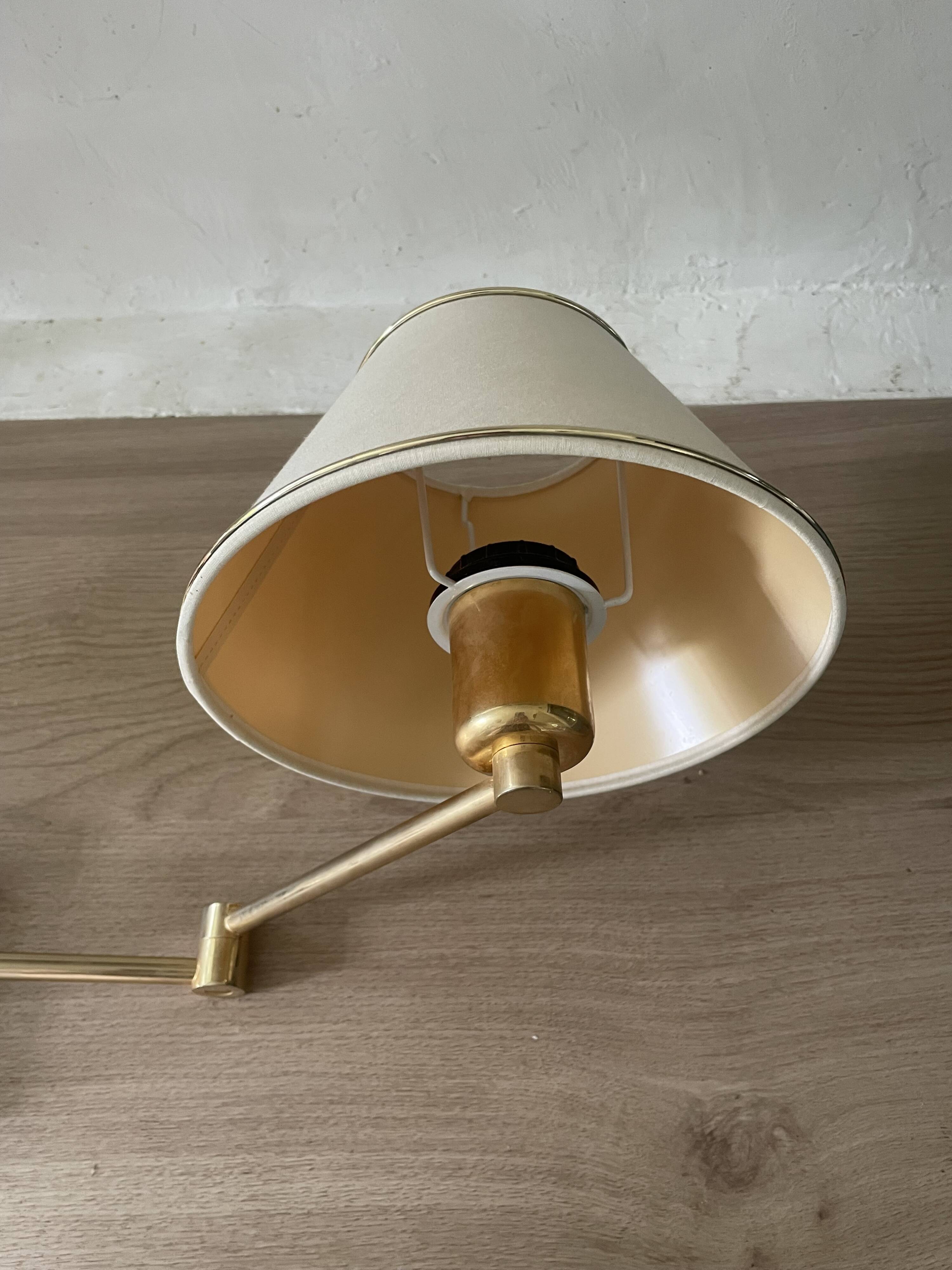 Pair of vintage brass wall lights with adjustable arms.