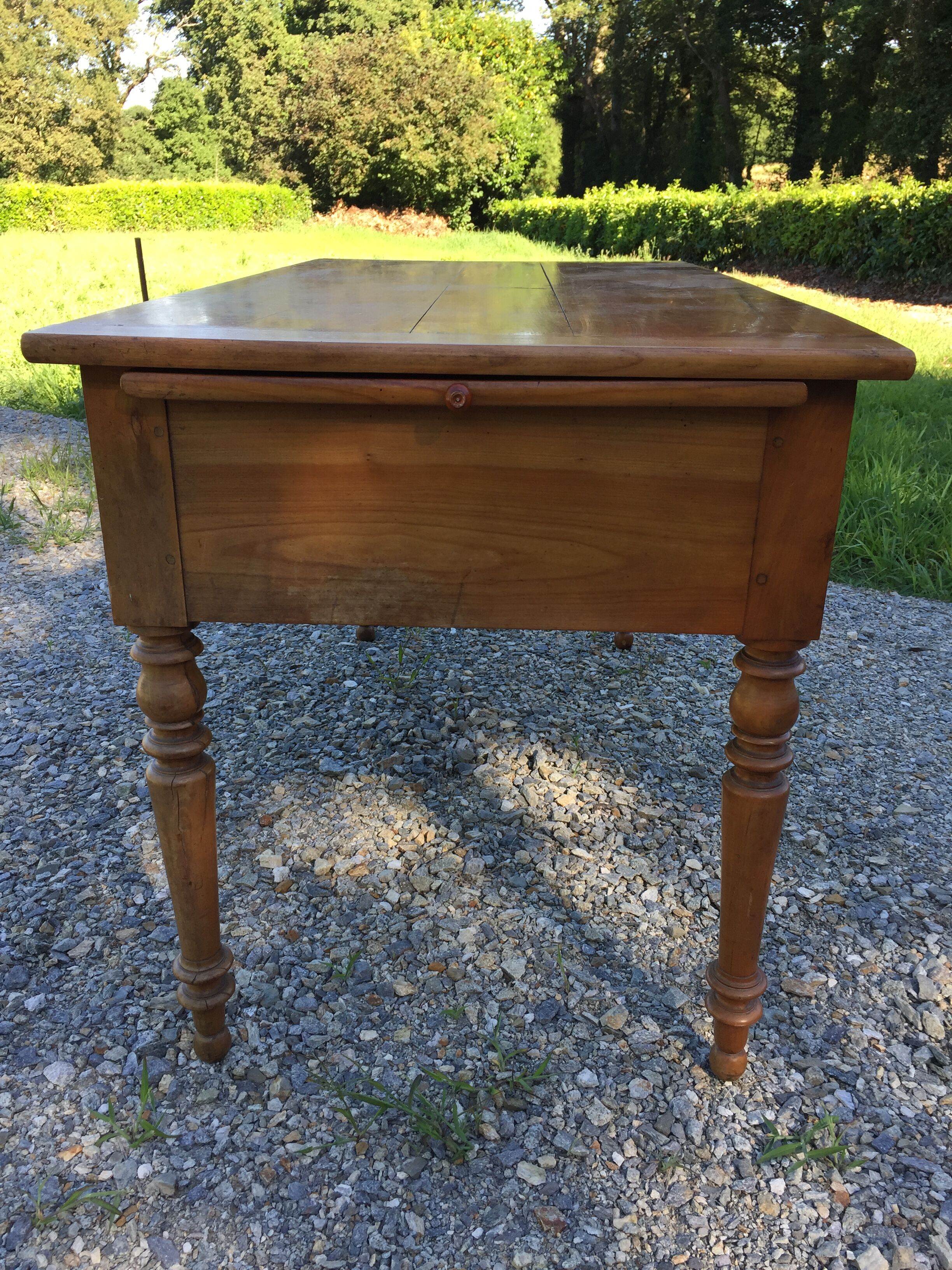 Old farmhouse table louis Philippe style in solid cherry with turned feet.