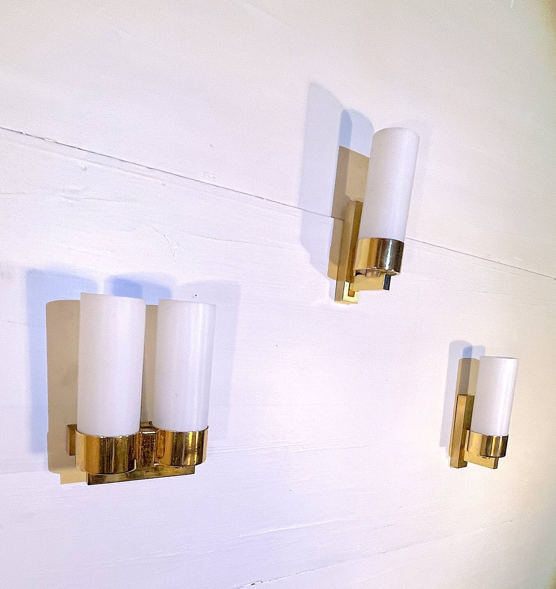 Set of three brass and opaline sconces, mid-century France