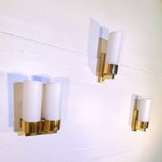 Set of three brass and opaline sconces, mid-century France