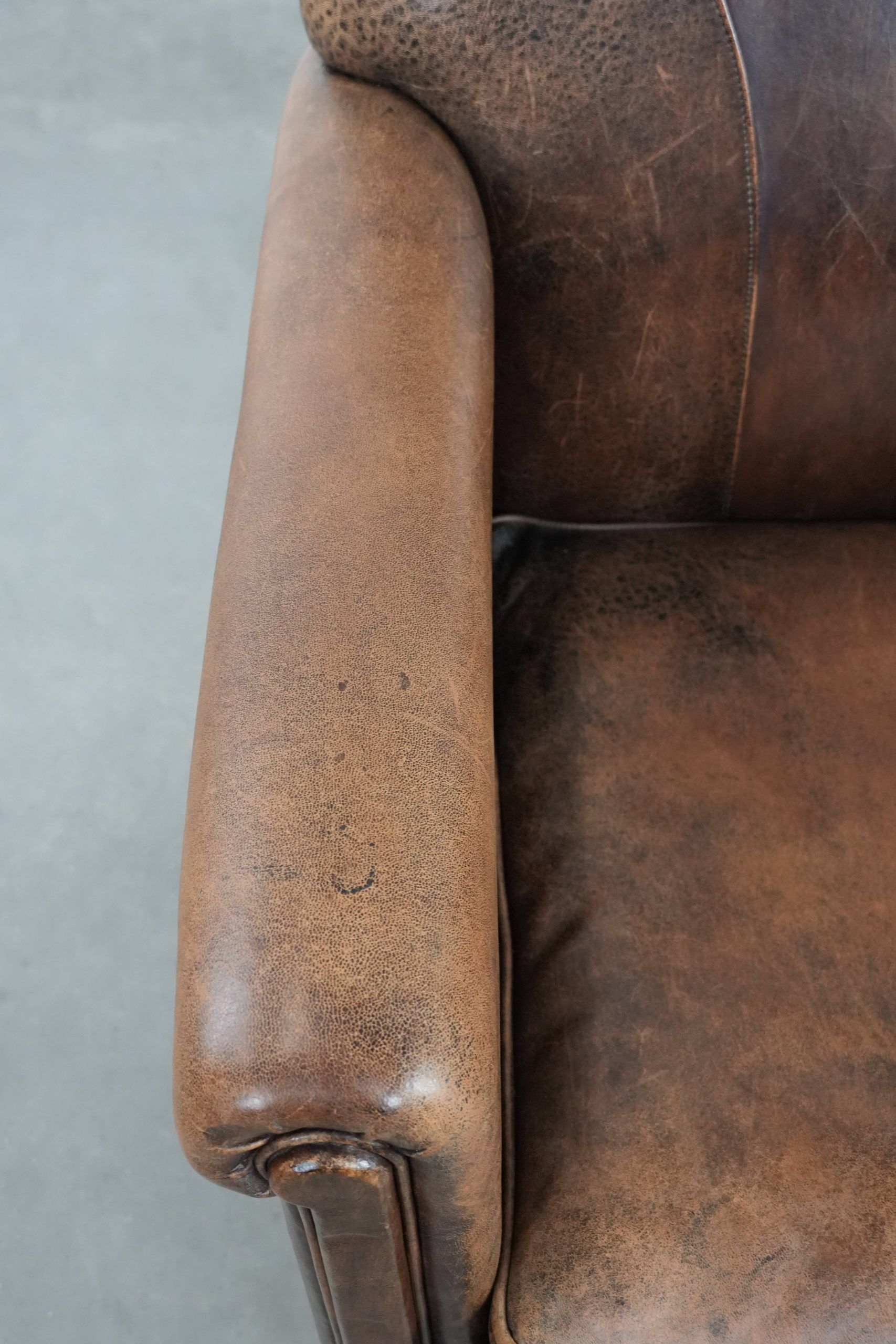 Vintage sheepskin armchair with warm colours and a characterful appearance