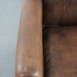 Vintage sheepskin armchair with warm colours and a characterful appearance