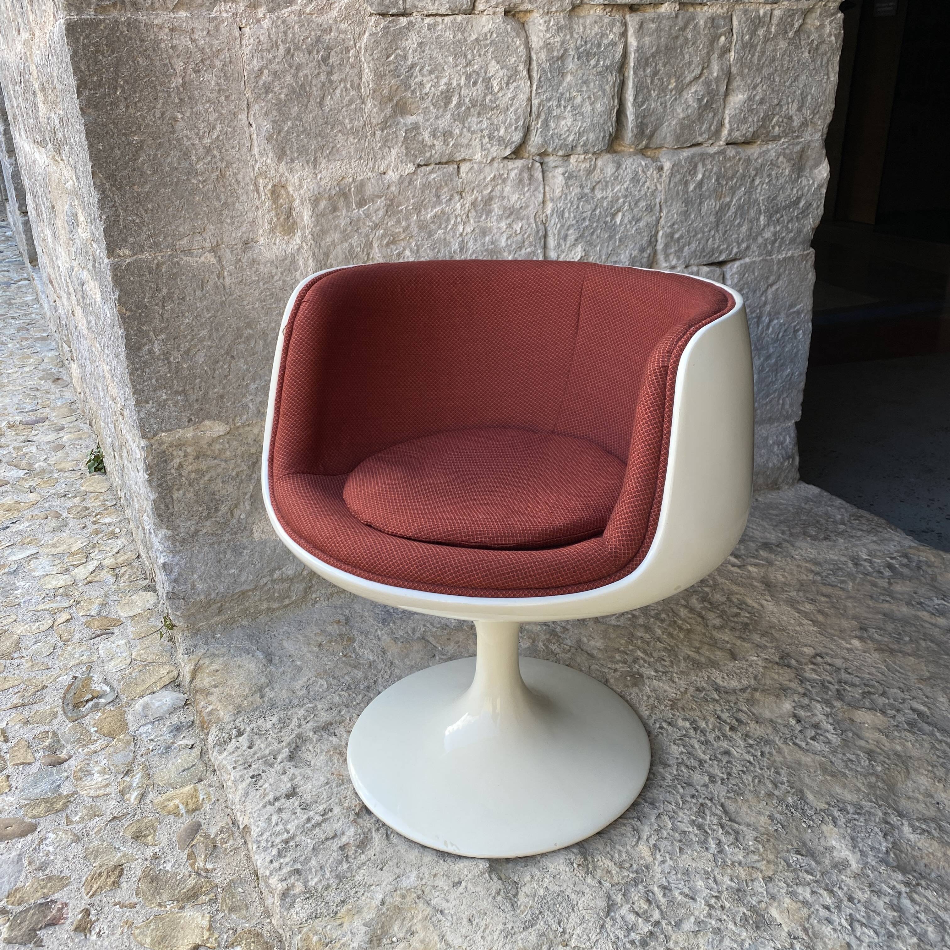 Two cognac-colored swivel chairs made of fiberglass from the 1970s
