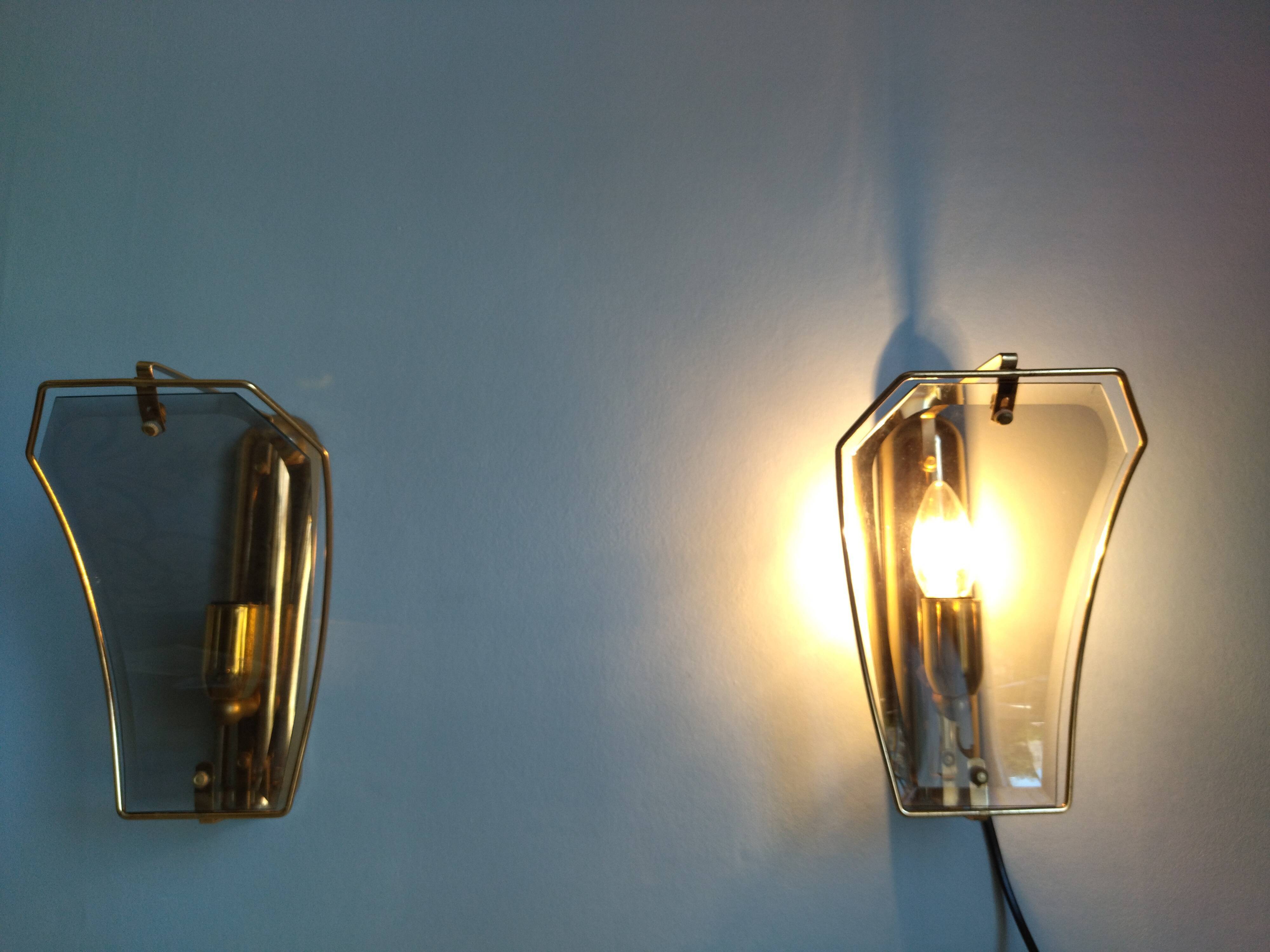 Pair of brass and curved glass wall lamps from the 80s