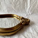 Old small wall mirror in golden resin