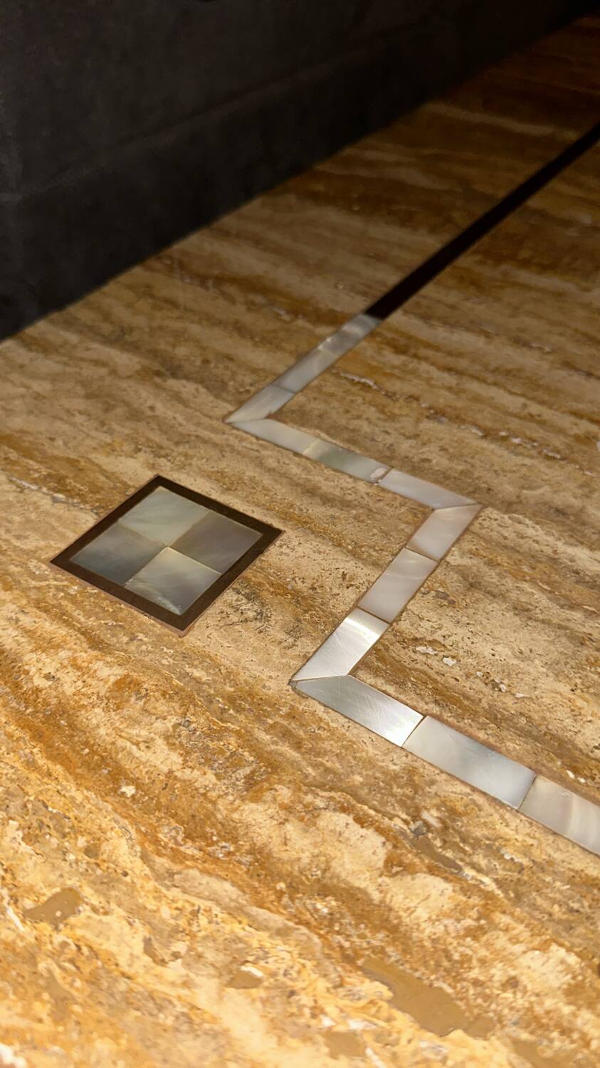 Coffee table in travertine with mother-of-pearl inlays.