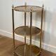 Round silver-plated brass table with triple eglomisé mirror tops from Maison Jansen.