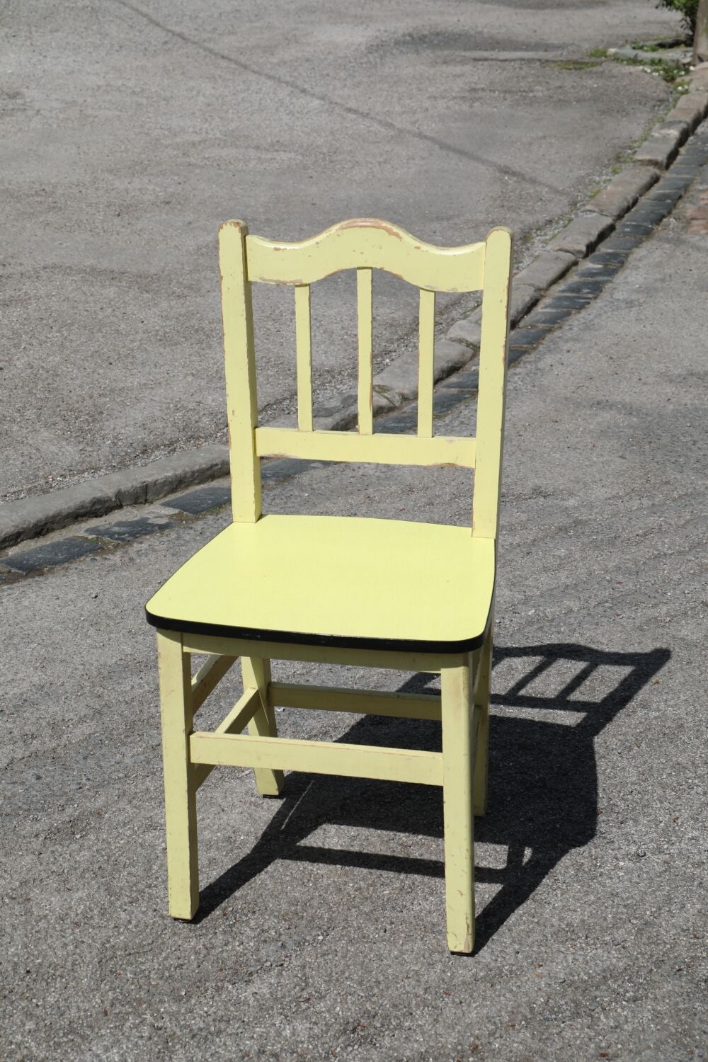 Formica and yellow wood chair