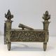 Pair of Empire Period Chenets in Chiselled Bronze with Torches and Leaf Frieze