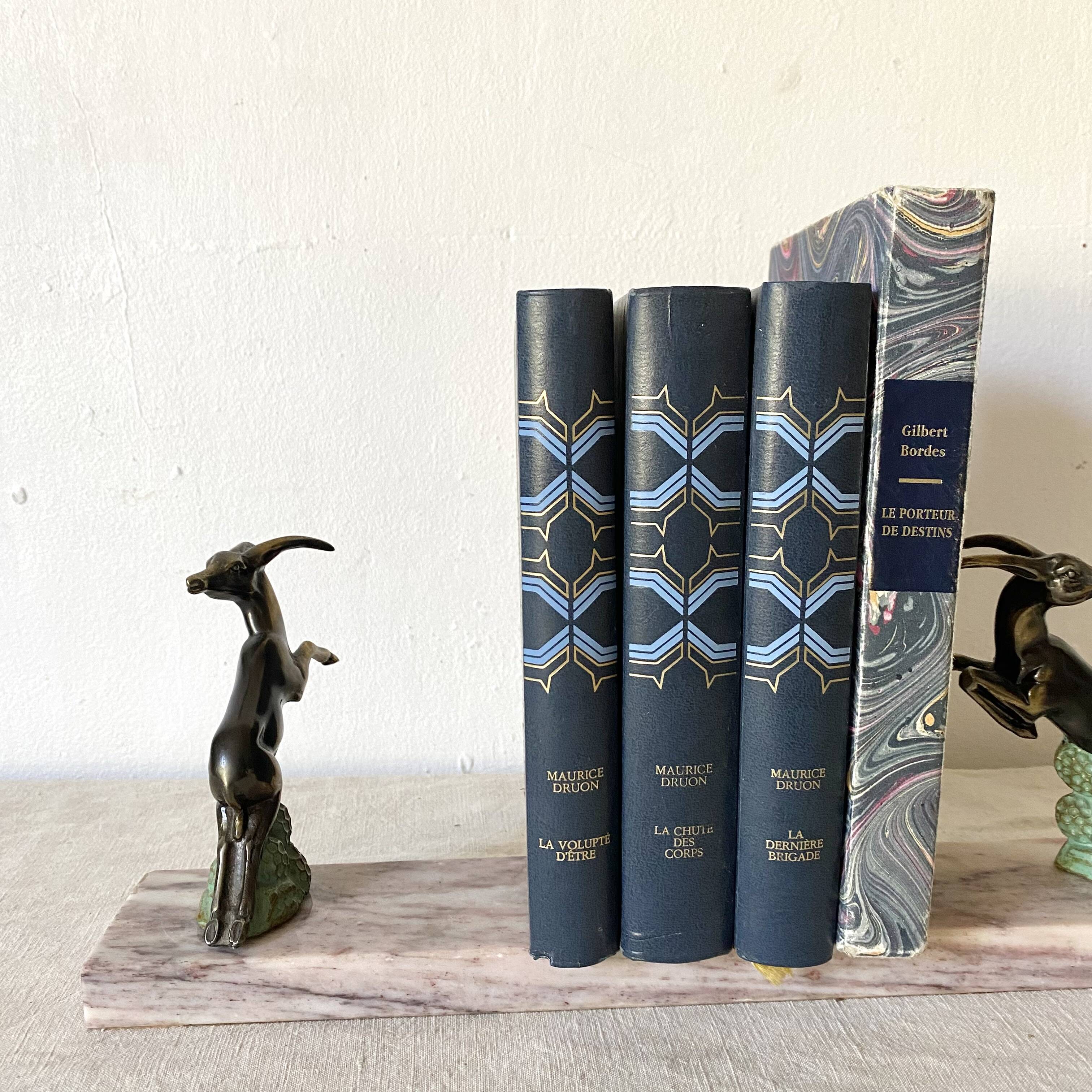 Art deco bookends in pink marble and spelters, antelopes