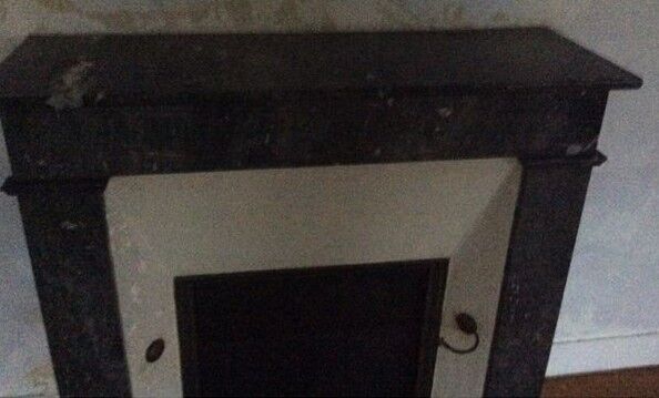 White veined black marble fireplace