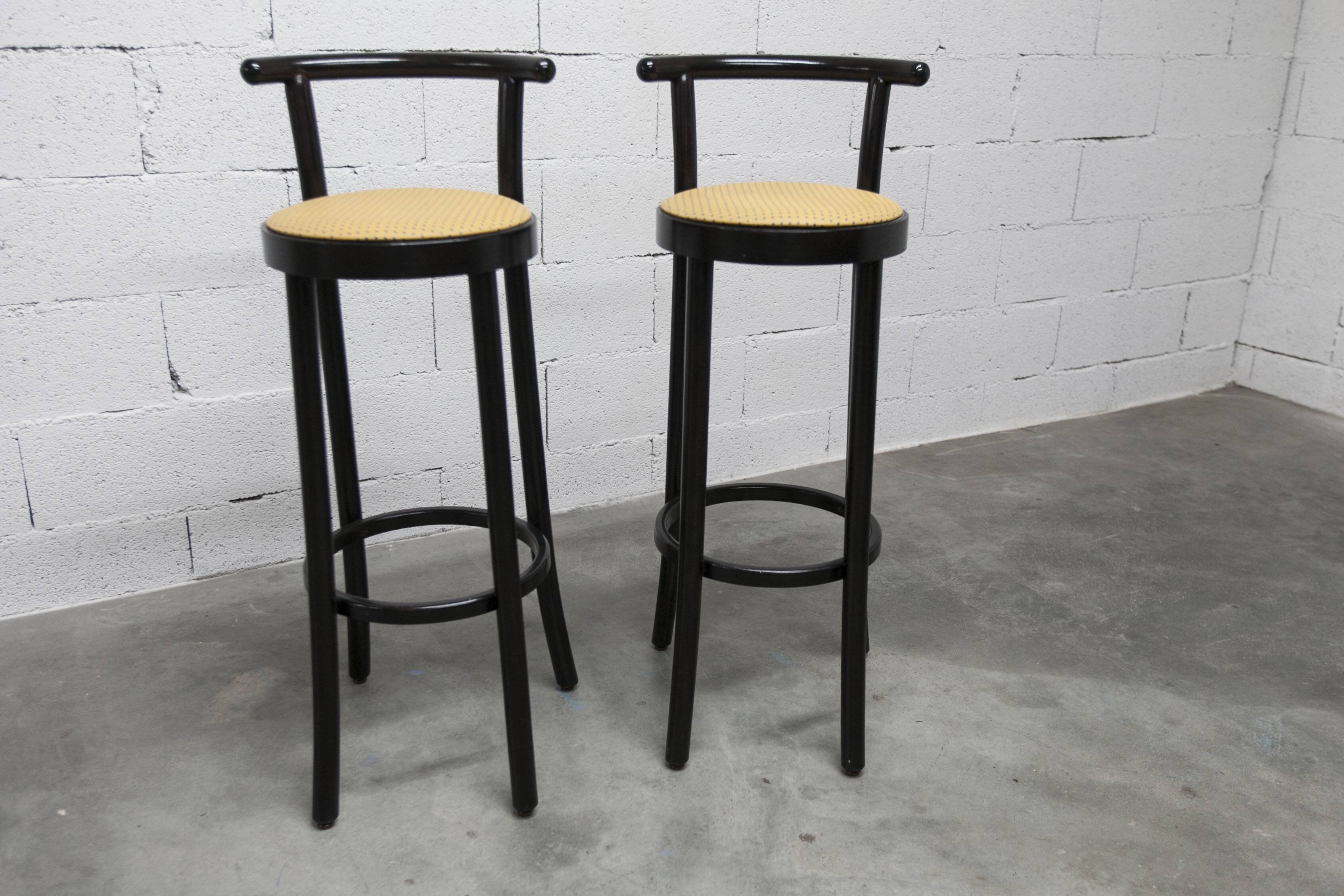 Pair of Baumann Dialog model stools in black and yellow and blue imitation leather, 1990