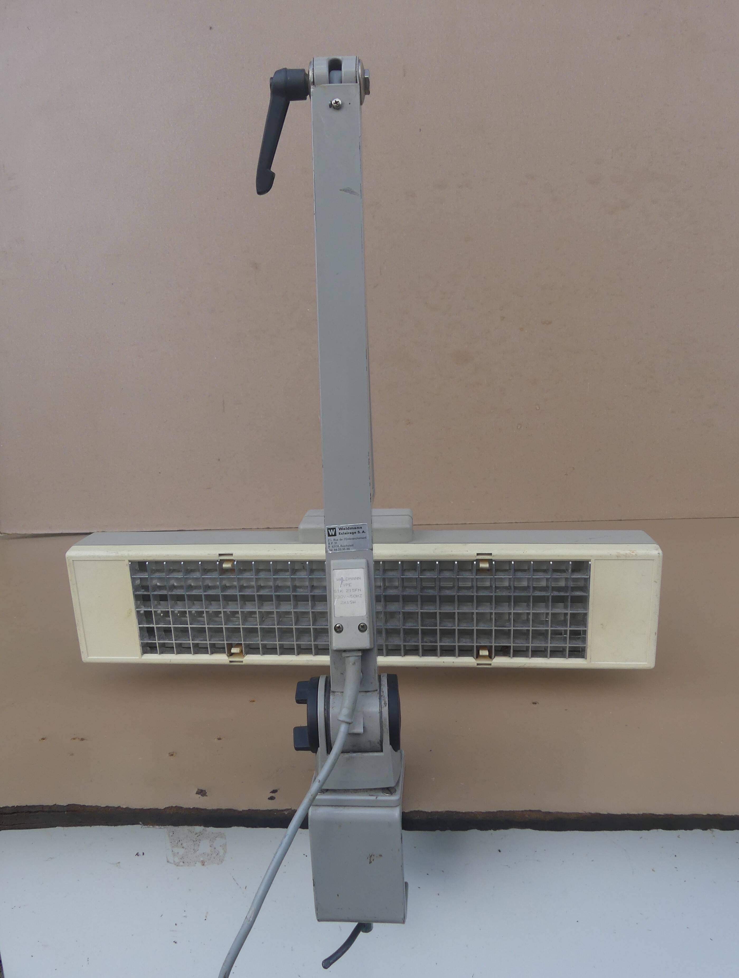 WALDMANN articulated workshop lamp with two industrial clamp arms for architects.