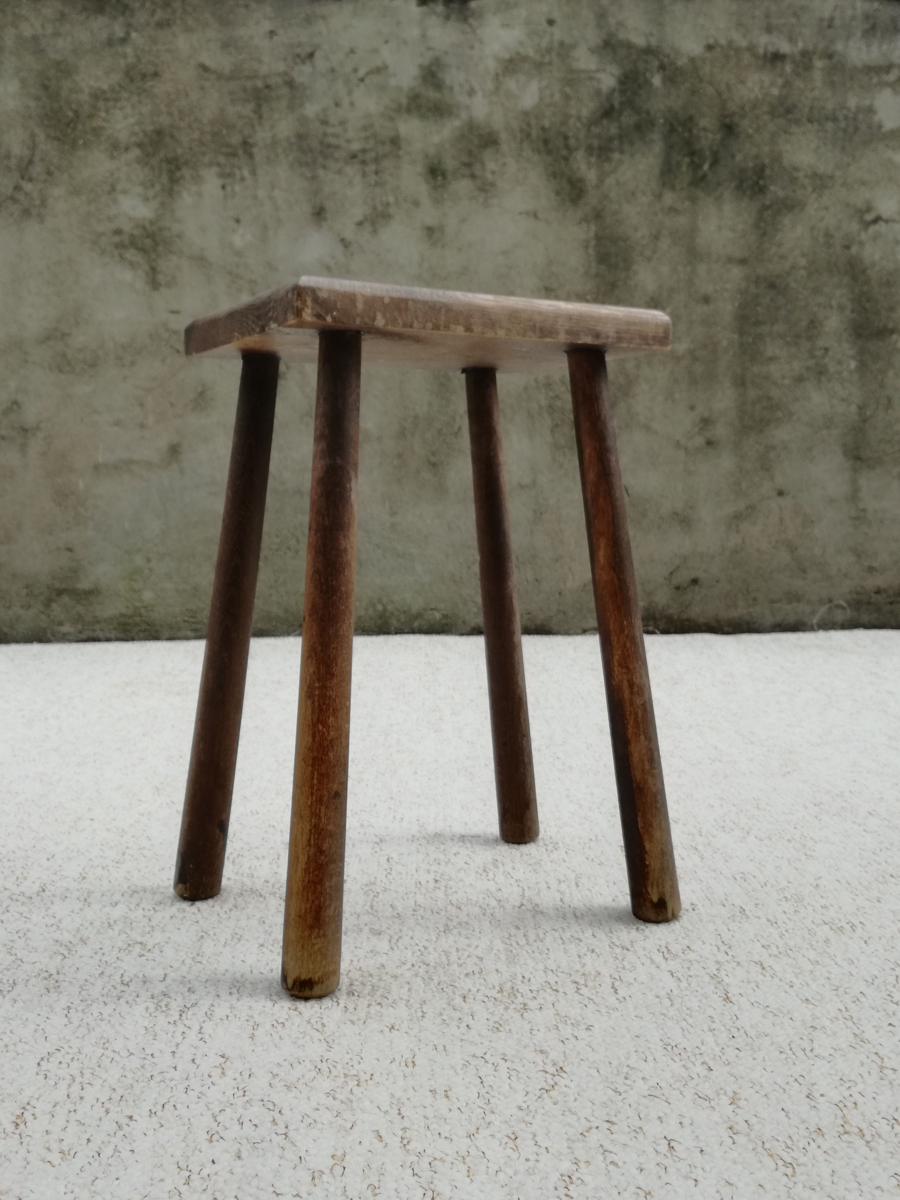 Old wooden stool with log feet