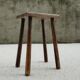 Old wooden stool with log feet
