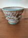 Hand-decorated earthenware cup