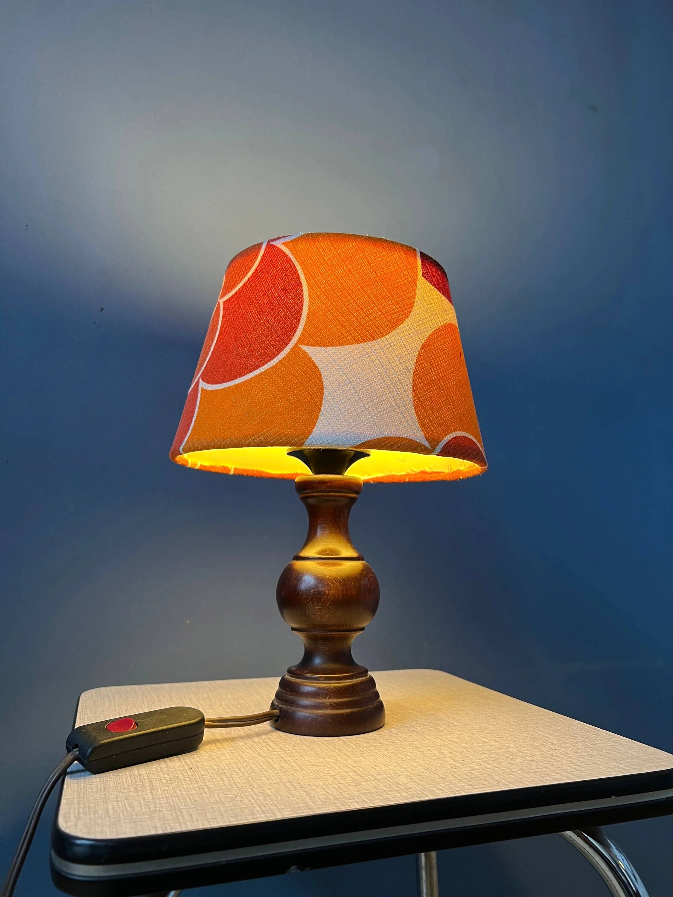Vintage Space Age table lamp with orange fabric shade.