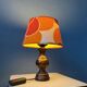 Vintage Space Age table lamp with orange fabric shade.