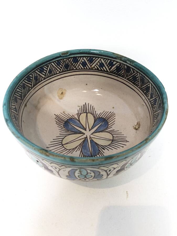 Cup on a ceramic pedestal – blue and turquoise geometric design.