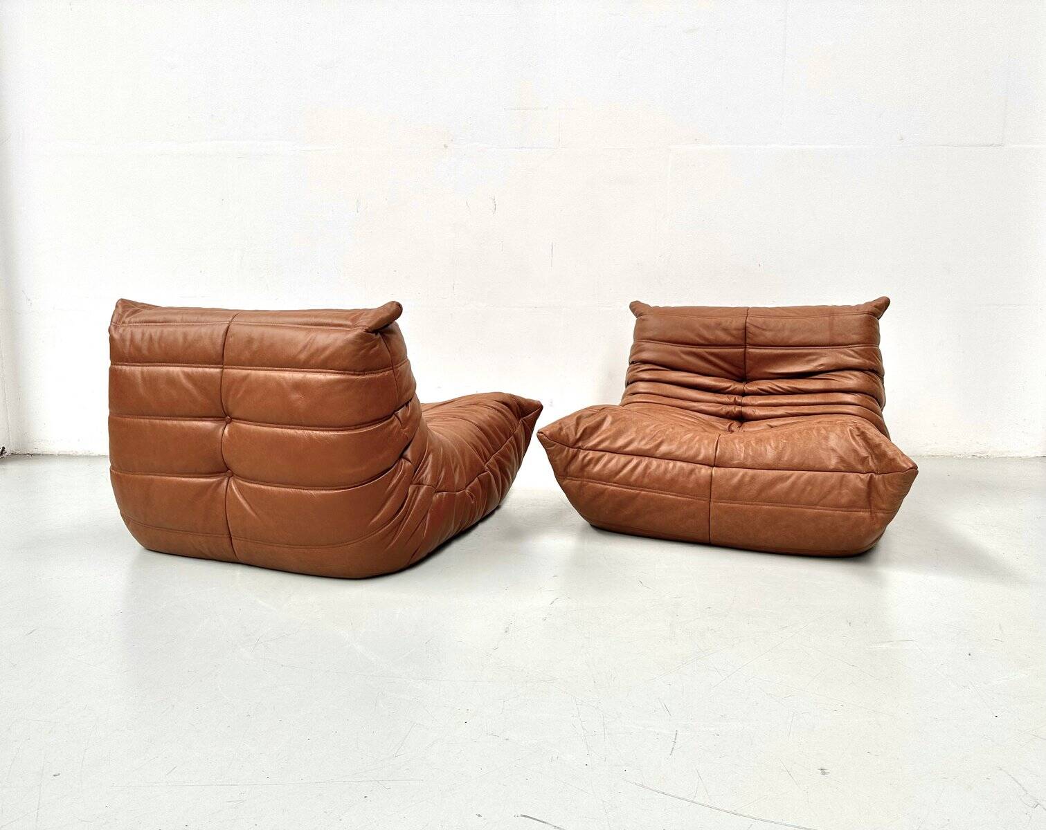 Togo lounge chairs in cognac cow leather attributed to Michel Ducaroy for Ligne Roset, set of 2