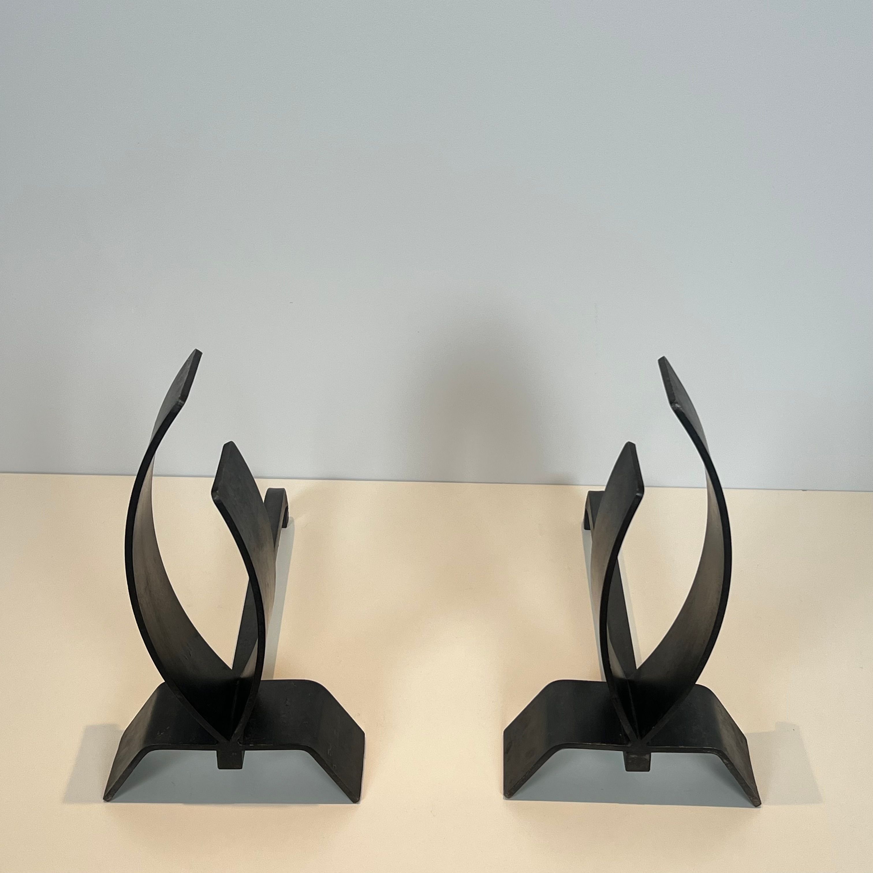 Pair of modernist andirons in steel and wrought iron