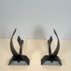 Pair of modernist andirons in steel and wrought iron