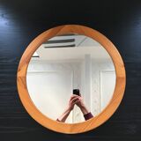 Round mirror in varnished pine