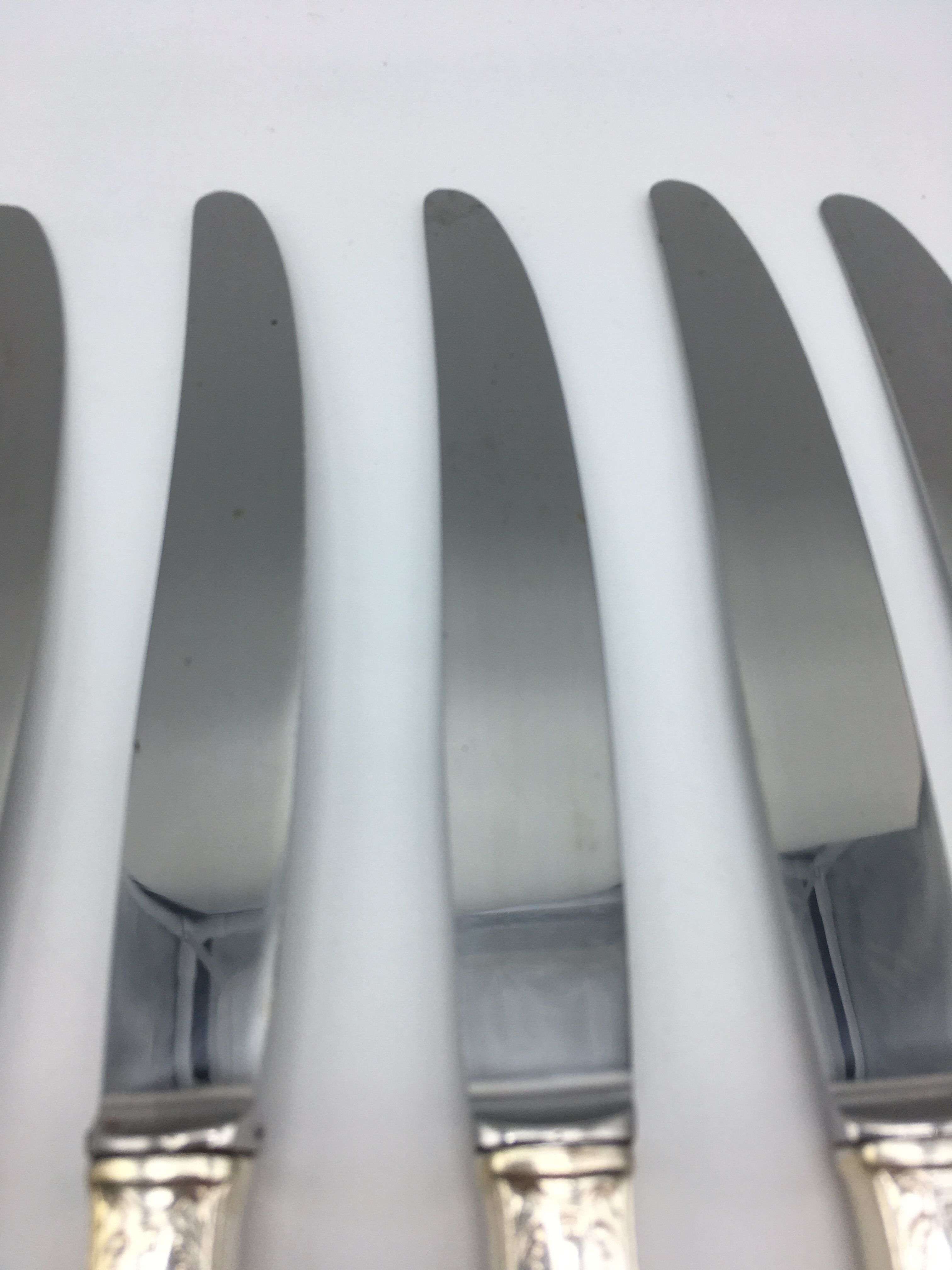 12 silver metal knives.