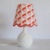 Small lamp with matte finish ceramic base and printed scalloped lampshade