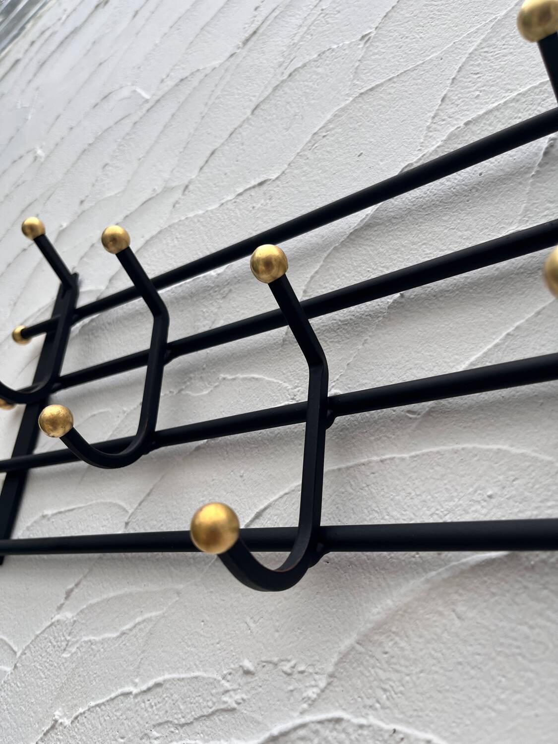 Iron and brass coat rack